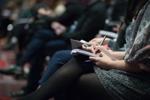 photo of people sitting with notebooks