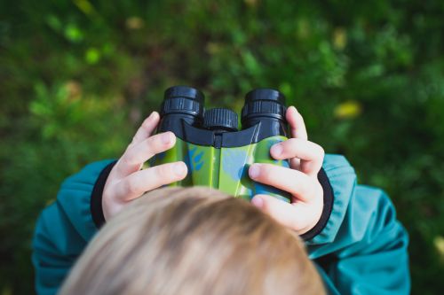 photo of a child with binoculars 