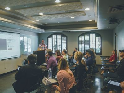 a photo of a classroom with students and a teacher