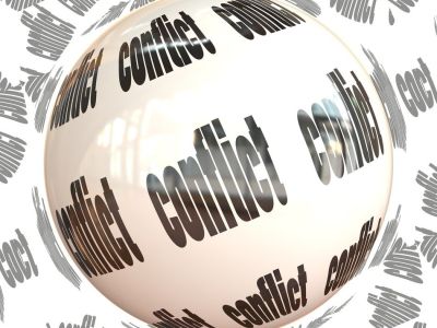 Image of the word conflict written multiple times on a ball.