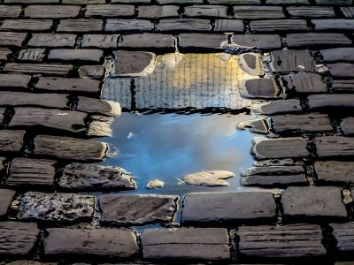Image of a reflection through a brick wall.