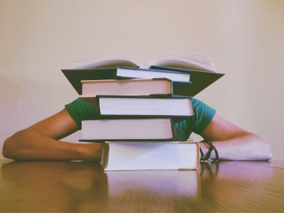 a person behind a stack of books