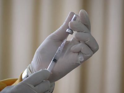 a hand filling a vaccine needle