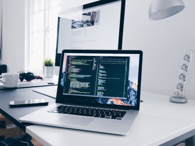 a laptop on a desk with data on the screen