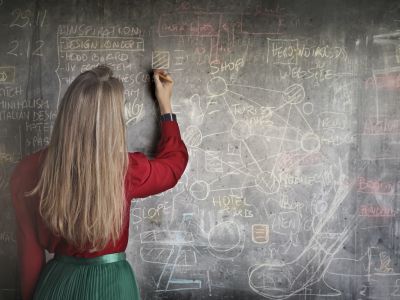 a woman at a chalkboard