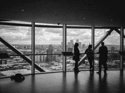 Image of people standing inside city building.