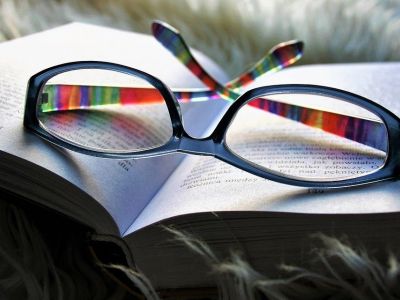 Image of glasses on top of a book.