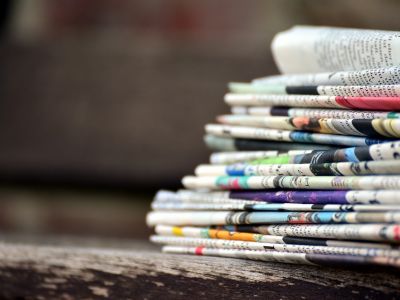 Photo of newspapers stacked.