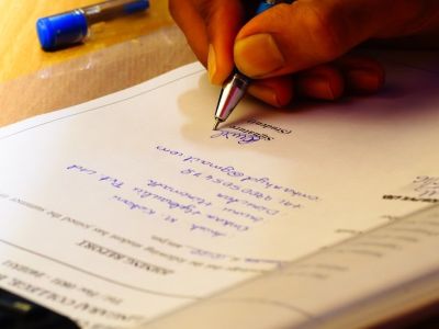 Photo of person signing documents.