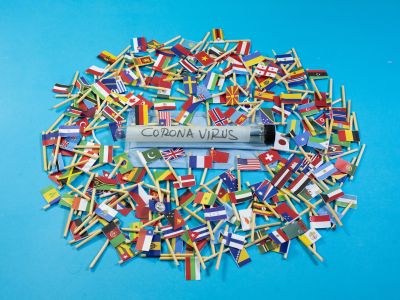 a scientific vial amongst world country flags