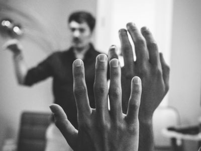 Image of hands raised during business meeting