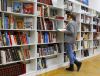 photo of a woman in front of a row of bookshelves